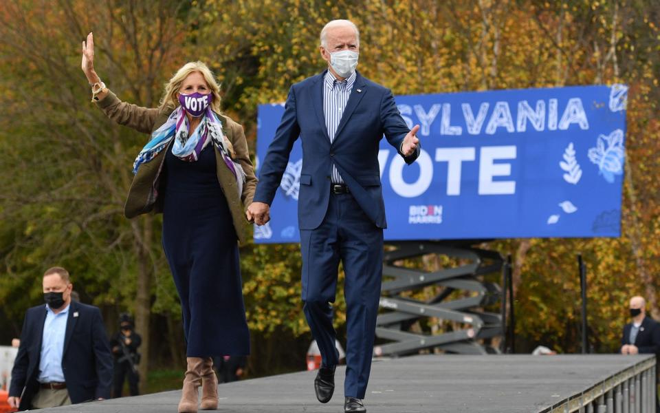 Democratic presidential candidate Joe Biden, with his wife Jill Biden, arrives to speak at a drive-in rally on the Bucks County Community College's Lower Bucks campus in Bristol, Pennsylvania - AFP