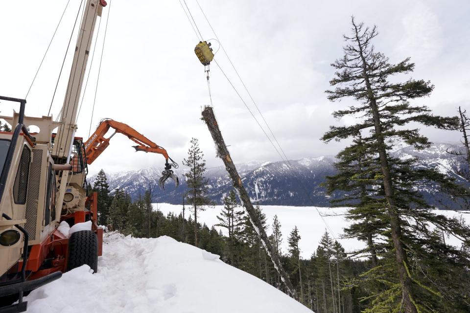 A log yarder hauls a log up a steep slope where a crew is thinning a 100-acre patch on private land owned by the Nature Conservancy in Cle Elum, Wash. The organization is cutting trees to restore the area’s pine forests and make them more resilient to wildfires and climate change. <a href="https://newsroom.ap.org/detail/CuttingTreesRestoringForests/32972bdffce540128237698cb55475f5/photo" rel="nofollow noopener" target="_blank" data-ylk="slk:AP Photo/Elaine Thompson;elm:context_link;itc:0;sec:content-canvas" class="link ">AP Photo/Elaine Thompson</a>