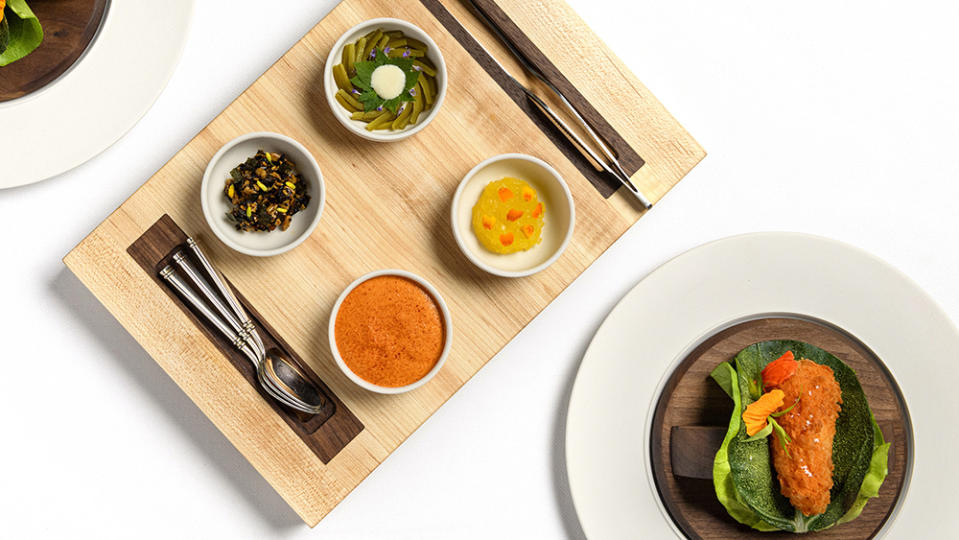 A selection of vegetable-based dishes, including fried peppers with Swiss chard, at Daniel Humm’s reimagined Eleven Madison Park. - Credit: Evan Sung