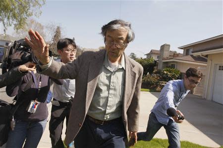 Satoshi Nakamoto is surrounded by reporters as he leaves his home in Temple City, California, March 6, 2014. REUTERS/David McNew