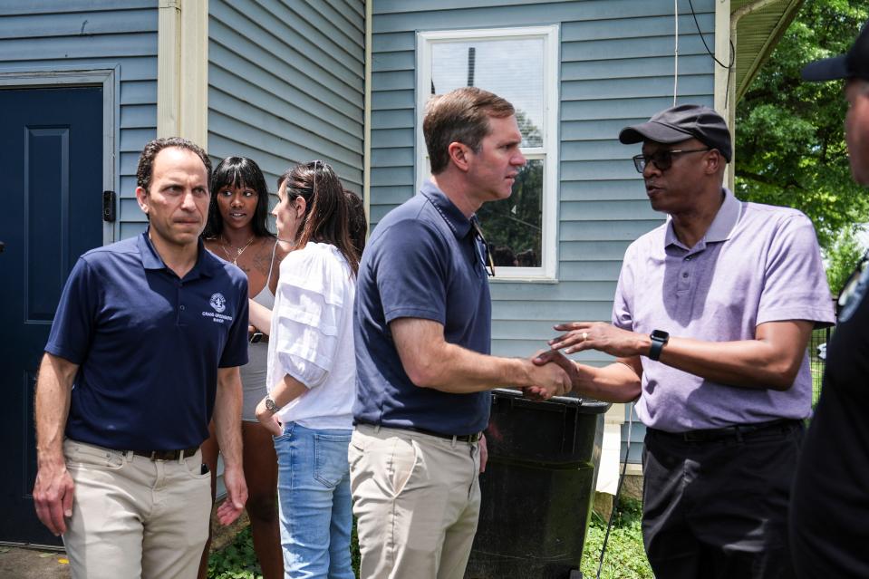 Gov. Andy Beshear visited west Louisville's Parkland neighborhood to talk to residents about the storm damage after an E1 tornado on the Fourth of July in Louisville, Kentucky. Several homes were damaged as well as a few cars crushed by fallen trees. No one was killed in the storm.