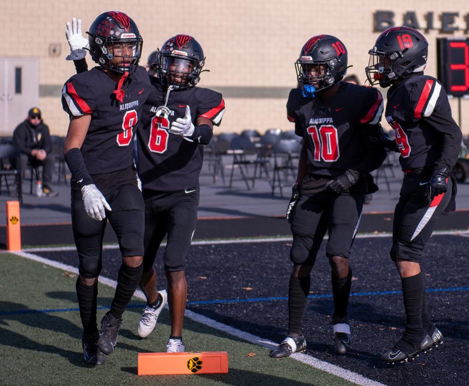 Aliquippa's Antonyo Anderson (8) gets congratulations from teammates after making a big catch at the 1 yard line, which led to a touchdown against Thomas Jefferson during the WPIAL Class 4A football championship at North Allegheny High School.