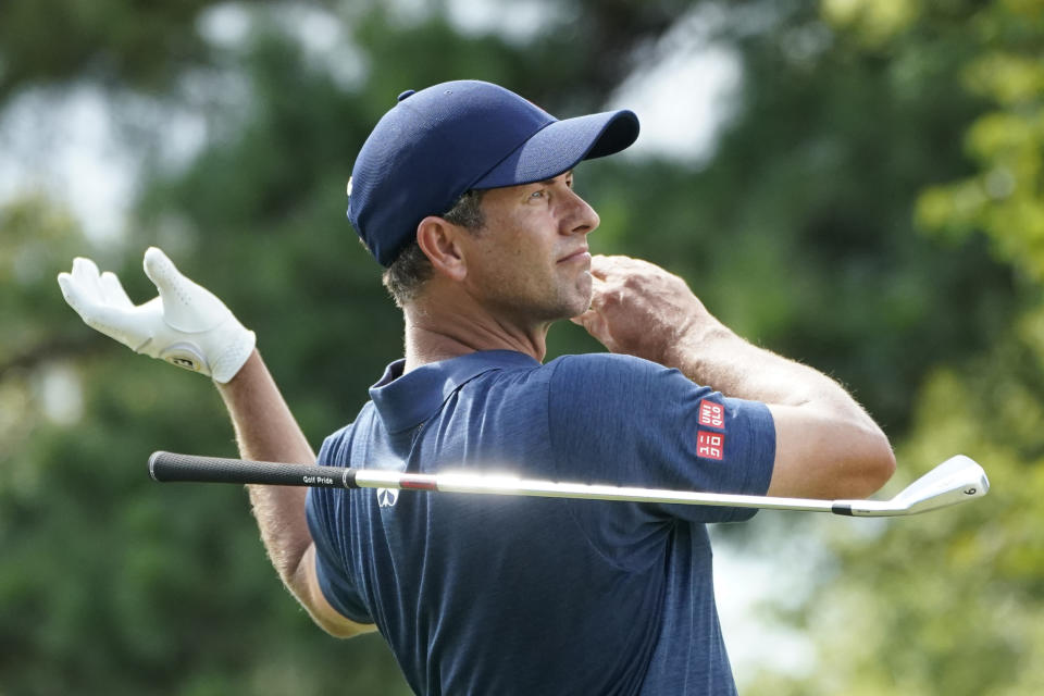 Adam Scott, of Australia, drops his club as he watches his shot from the 14th tee during the first round of the St. Jude Championship golf tournament Thursday, Aug. 11, 2022, in Memphis, Tenn. (AP Photo/Mark Humphrey)