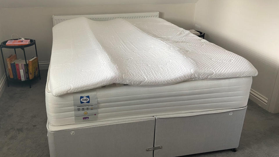 The Puffy Deluxe Mattress Topper laid out on a bed just after being unwrapped