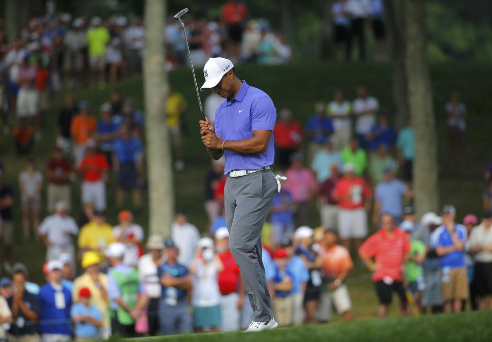 Tiger Woods of the U.S. reacts to a missed putt on the 10th green during the first round of the 2014 PGA Championship at Valhalla Golf Club in Louisville, Kentucky, August 7, 2014. REUTERS/Brian Snyder