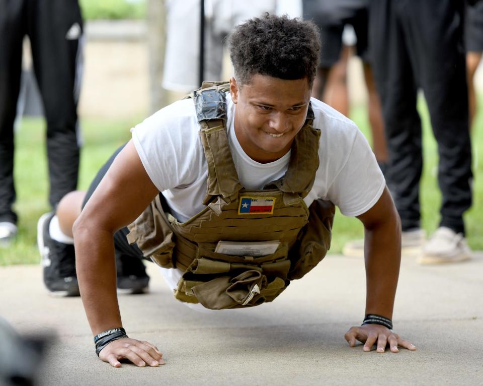 Walsh University freshman Dominic Leon of Plain Township completed 45 pushups Thursday while wearing a 30-pound vest at an event hosted by Walsh University in conjunction with National Suicide Awareness Week. Participants were challenged to do 22 pushups to raise awareness of the 22 suicide deaths among veterans every day.