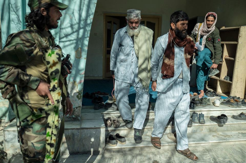 Taliban security guards escort an Afghan man (centre L), who has been sentenced to death for murder, and another prisoner after a hearing at the Ghazni Court of Appeal in Ghazni, eastern Afghanistan,   November 28, 2022. / Credit: WAKIL KOHSAR/AFP via Getty Images