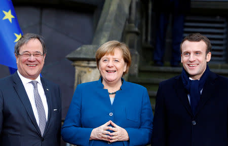 Armin Laschet, federal premier of Germany's North Rhine-Westphalia, German Chancellor Angela Merkel and French President Emmanuel Macron attend a signing of a new agreement on bilateral cooperation and integration, known as Treaty of Aachen, in Aachen, Germany, January 22, 2019. REUTERS/Thilo Schmuelgen