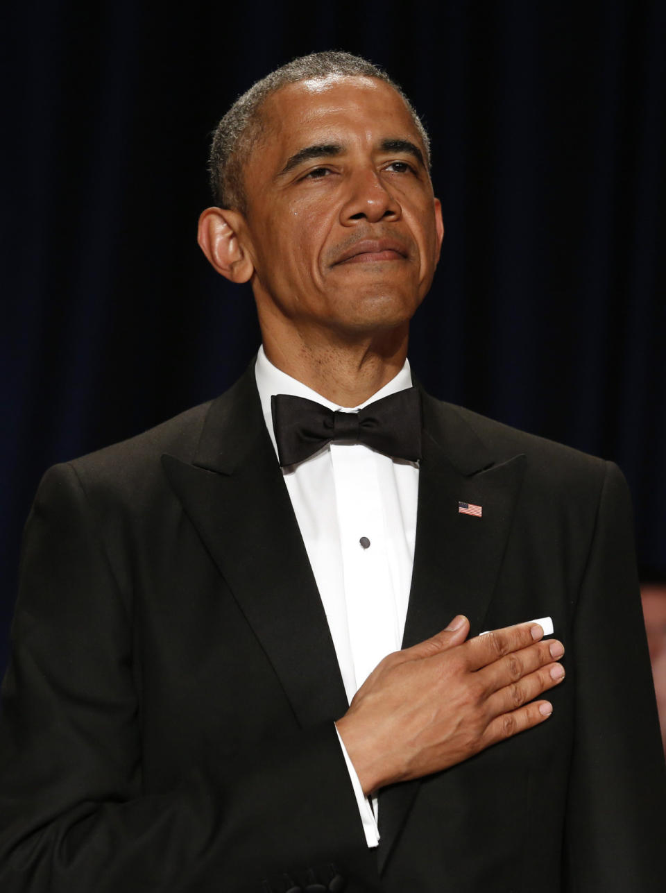  Before revealing his megawatt smile, the President stood at attention for the National Anthem looking proud and as dapper as ever.