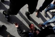 A wounded Palestinian demonstrator is helped during a protest against Israeli settlements, near the town of Beita in the Israeli-occupied West Bank