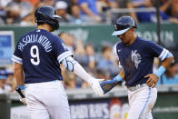 Kansas City Royals' Nicky Lopez, right, is congratulated by Vinnie Pasquantino (9) after scoring from third on Andrew Benintendi's single during the third inning of the team's baseball game against the Tampa Bay Rays in Kansas City, Mo., Friday, July 22, 2022. (AP Photo/Colin E. Braley)