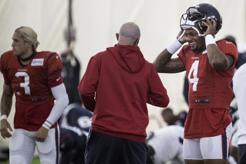 Houston Texans quarterback Deshaun Watson (4) talks to Jack Easterby, executive vice president, football operations, during an NFL training camp football practice Friday, Aug. 14, 2020, at The Houston Methodist Training Center in Houston. (Brett Coomer/Houston Chronicle via AP)