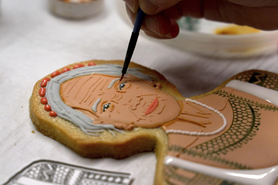 Jasmine Cho works on a cookie portrait of Filipina mambabatok tattoo artist Apo Whang-Od in Pittsburgh, Pa., Wednesday, May 3, 2023. Cho, a Korean American self-described “cookie activist,” has gained fans over the last several years for her finely detailed cookie mugs of famous and forgotten figures. (AP Photo/Matt Freed)