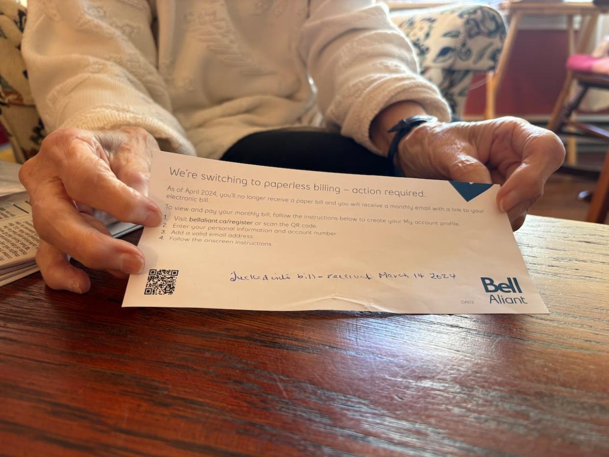 Bernice Morgan, an 89-year-old St. John's resident, received this notice with her March phone and TV bill. (Darrell Roberts/CBC - image credit)
