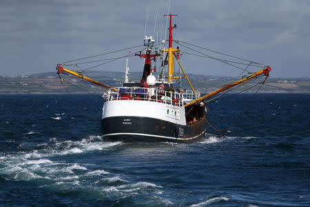 FILE PHOTO: A fishing vessel leaves a port in Newlyn, Britain August 9, 2017. REUTERS/Neil Hall/File Photo