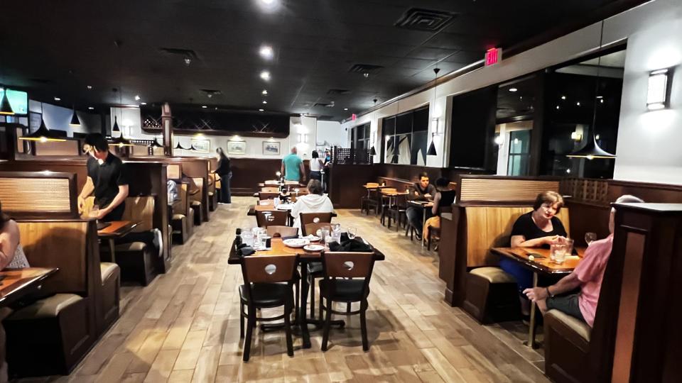 At Fin & Flame Grill and Oyster Bar in Palm City, some of the ship vibe remains from the previous Palm City Grill, with lots of wood, booths and copper-topped tables.