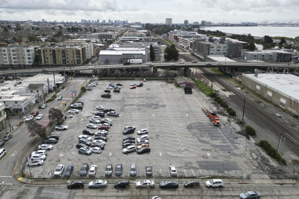 An aerial view shows a parking lot that was once the Shellmound village site in Berkeley, Calif., Tuesday March 12, 2024. The Berkeley City Council on Tuesday will consider a settlement to return land that once held the Shellmound village site, a ceremonial and burial site, to the Sogorea Te' Land Trust, a Bay Area collective that works to return land to Indigenous people. (AP Photo/Terry Chea)