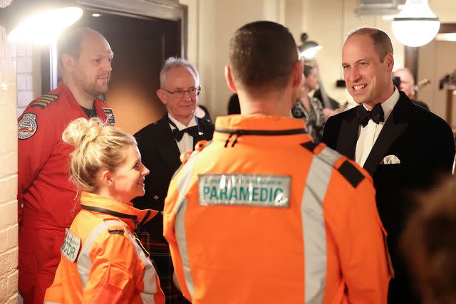 <p>DANIEL LEAL/POOL/AFP via Getty</p> Prince William speaks with paramedics at the London Air Ambulance Charity Gala on Feb. 7, 2024