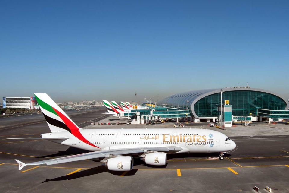 A fleet of Emirates planes on the tarmac at an airport