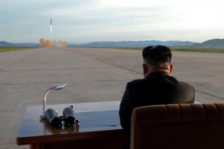 North Korean leader Kim Jong Un watches the launch of a Hwasong-12 missile in this undated photo released by North Korea's Korean Central News Agency (KCNA) on September 16, 2017. KCNA via REUTERS