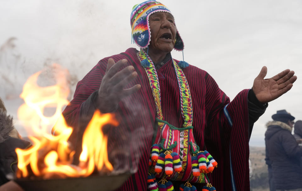 El líder espiritual José Mamani quema ofrendas en honor de la Pachamama, o Madre Tierra, antes de recibir los primeros rayos de sol del día como parte de un ritual por el Año Nuevo Andino en el cerro Turriturrini a las afueras de Huarina, Bolivia, el viernes 21 de junio de June 21, 2024. Comunidades indígenas aymaras celebran el año nuevo 5.532 o el "Willka Kuti" que significa "Regreso del Sol" en aymara. (AP Foto/Juan Karita)