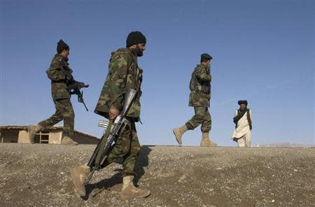 Afghan National Army and U.S. soldiers walk on patrol in the town of Shah joy in Zabul province, southern Afghanistan