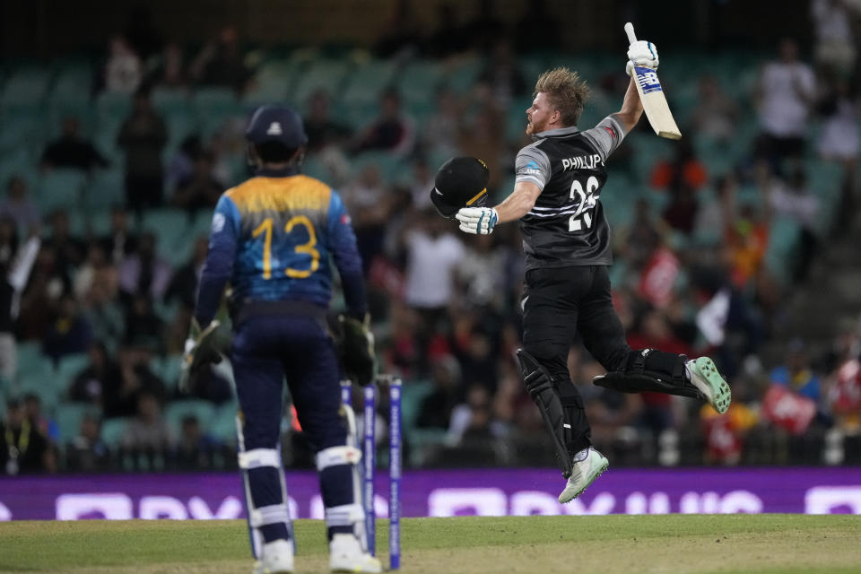 New Zealand's Glenn Phillips, right, jumps up in fromt of Sri Lanka's Kusal Mendis as he celebrates making a century during their T20 World Cup Cricket match in Sydney, Australia, Saturday, Oct. 29, 2022. (AP Photo/Mark Baker)