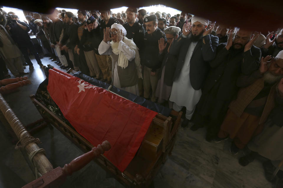 People attend the funeral prayer for a police officer killed in Monday's suicide bombing inside a mosque in Peshawar, Pakistan, Tuesday, Jan. 31, 2023. The death toll from the previous day's suicide bombing at a mosque in northwestern Pakistani rose to more than 85 on Tuesday, officials said. The assault on a Sunni Mosque inside a major police facility was one of the deadliest attacks on Pakistani security forces in recent years. (AP Photo/Muhammad Sajjad)