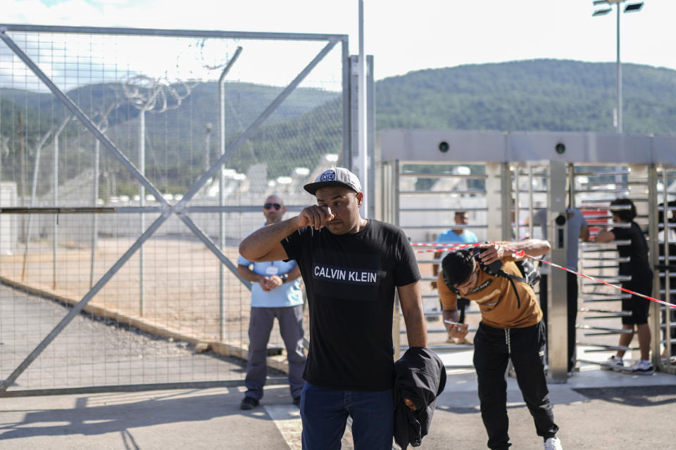 A man cries after speaking with survivors of a deadly migrant boat sinking at a migrant camp in Malakasa north of Athens, on Monday, June 19, 2023. Hundreds of migrants are believed to be missing after a fishing trawler sank off southern Greece last week. (AP Photo/Petros Giannakouris)