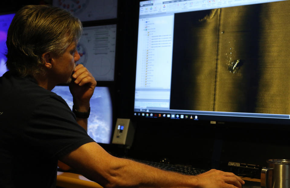 Rob Kraft, director of undersea operations at Vulcan Inc., reviews sonar scans of a warship from the World War II Battle of Midway that was found by the crew of the research vessel Petrel, Sunday, Oct. 20, 2019, off Midway Atoll in the Northwestern Hawaiian Islands. (AP Photo/Caleb Jones)