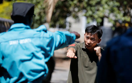 Chinese national Jack Wang, a security trainer at the Chinese-run Deway Security Group leads Kenyan security guards in martial arts combat training at their company compound in Kenya's capital Nairobi, March 13, 2017. REUTERS/Thomas Mukoya