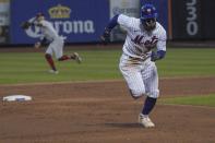 New York Mets' Francisco Lindor runs from second base to score aa run during the third inning of a baseball game against the Cincinnati Reds, Monday, Aug. 8, 2022, in New York. (AP Photo/Bebeto Matthews)