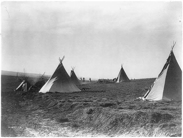 Several tipis in open area photographed in 1905.