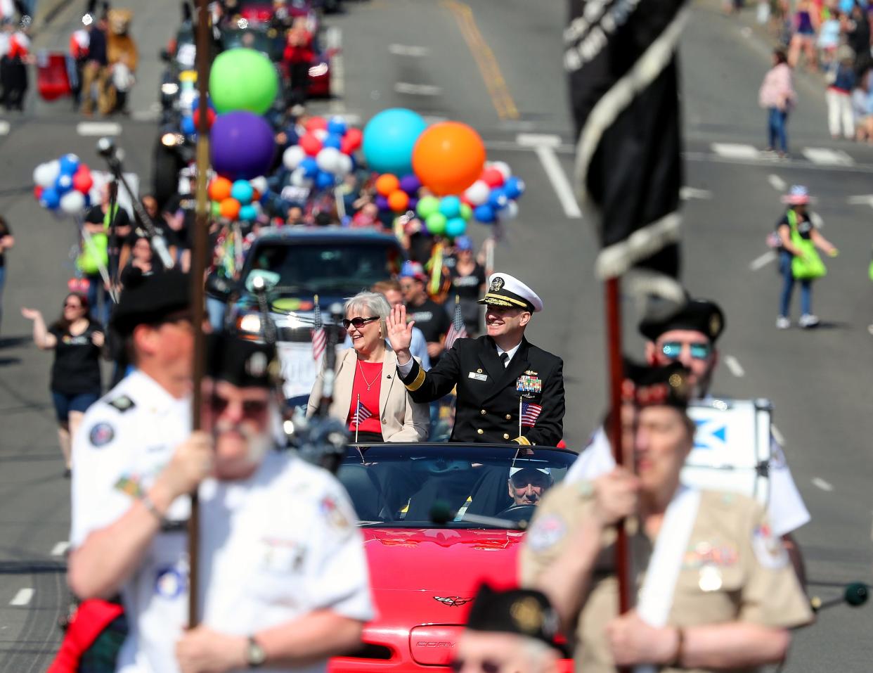 The 76th Armed Forces Day Parade Grand Marshall Rear Admiral Mark Behning, the commander of Submarine Group Nine and Task Group 114.3, waves to the crowd as the parade moves down 6th in Bremerton on Saturday, May 20, 2023.