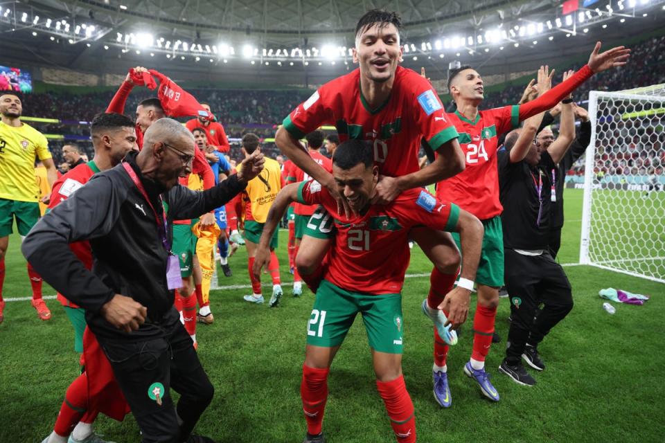 Morocco’s Achraf Dari with Walid Cheddira and teammates celebrate after the match as Morocco progress to the semi finals (REUTERS)