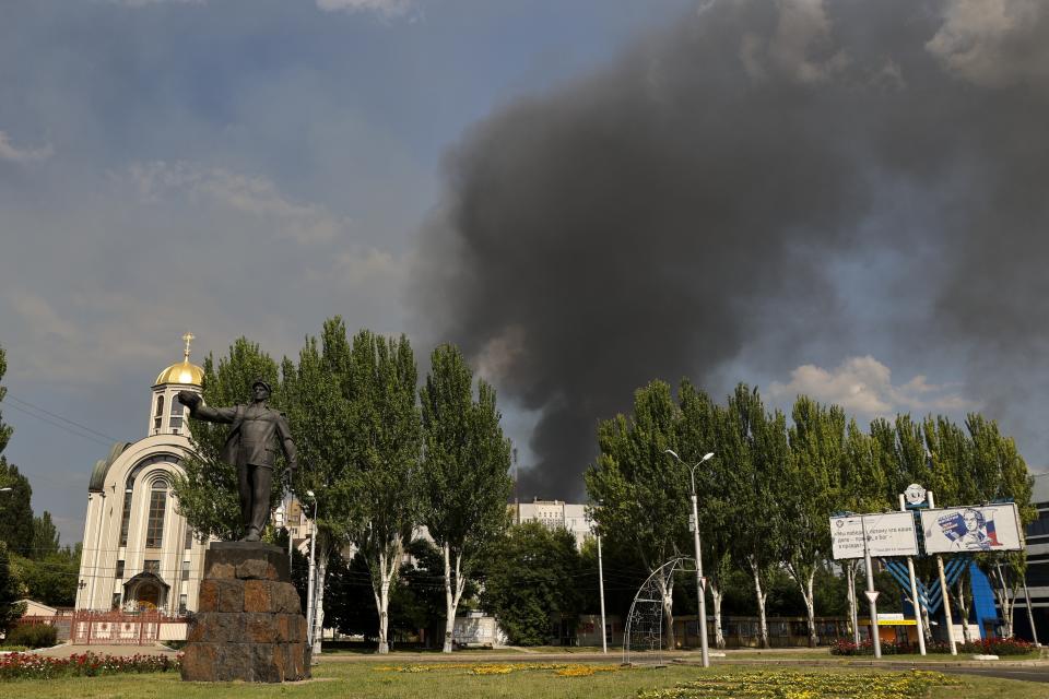 Smoke rises from a burning house following shelling in Donetsk, on the territory which is under the Government of the Donetsk People's Republic control, eastern Ukraine, Friday, June 17, 2022. (AP Photo/Alexei Alexandrov)