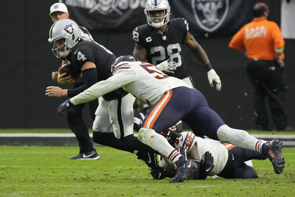 Chicago Bears outside linebacker Khalil Mack (52) tackles Las Vegas Raiders quarterback Derek Carr (4) during the second half of an NFL football game, Sunday, Oct. 10, 2021, in Las Vegas. (AP Photo/Rick Scuteri)