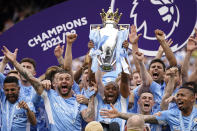 Manchester City players celebrate with trophy after winning the 2022 English Premier League title at the Etihad Stadium in Manchester, England, Sunday, May 22, 2022. (AP Photo/Dave Thompson)