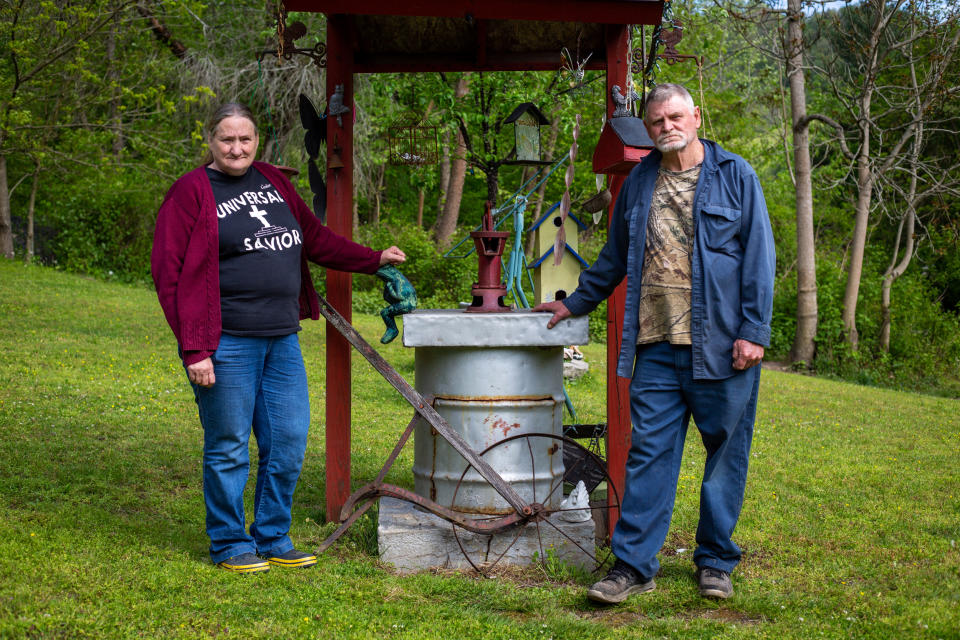 Hazel and Burlyn Cooper stand near their hand-dug well, one of two wells on their property that went bad after a natural gas well was installed nearby. (Hannah Rappleye / NBC News)