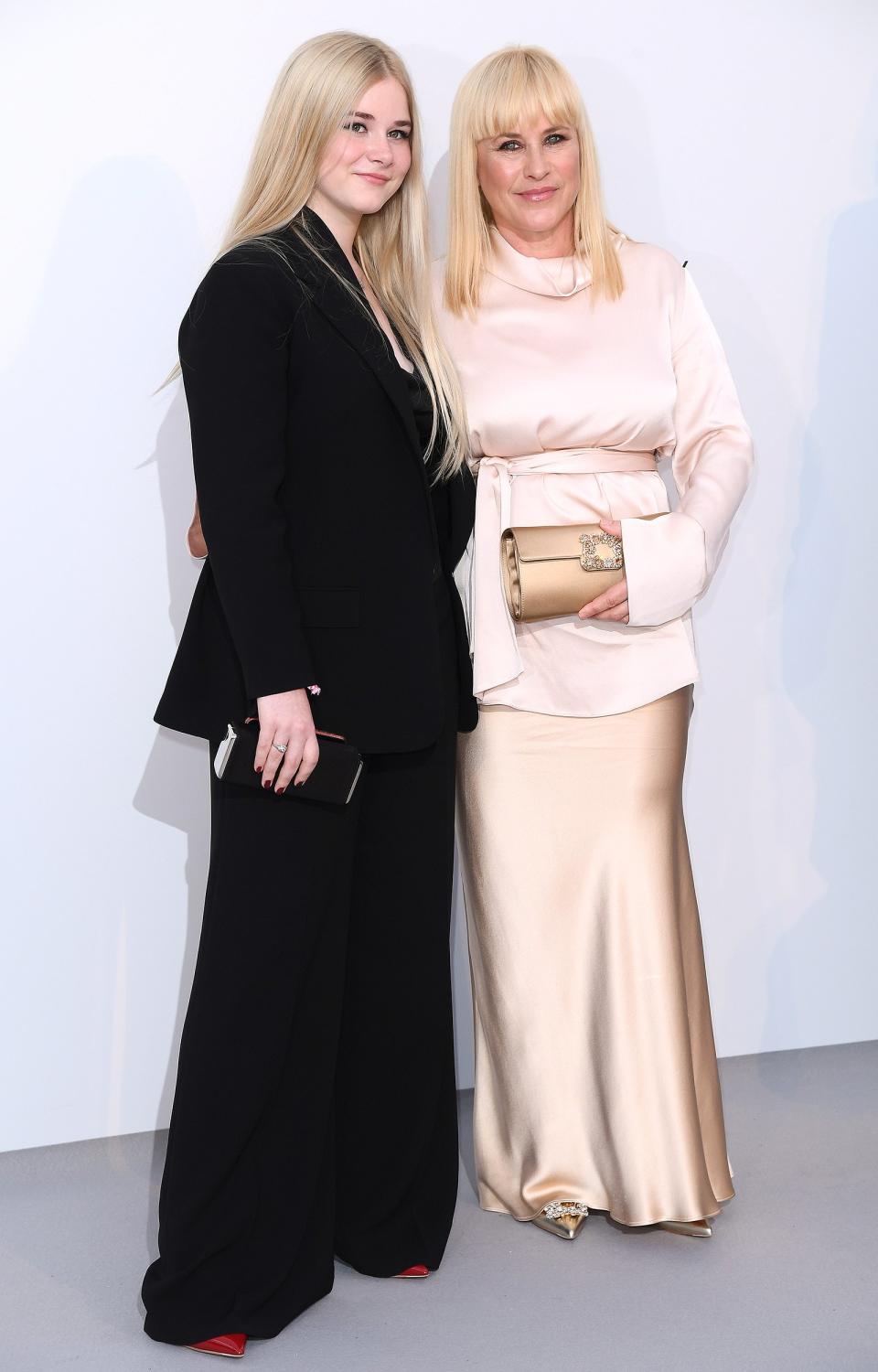 The mother-daughter duo have a glam night out at the amfAR Gala. Harlow wears a black suit, while Patricia opts for a light pink belted top with champagne-colored skirt, clutch and shoes (both Roger Vivier). 