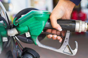 Female hand refilling the car with fuel