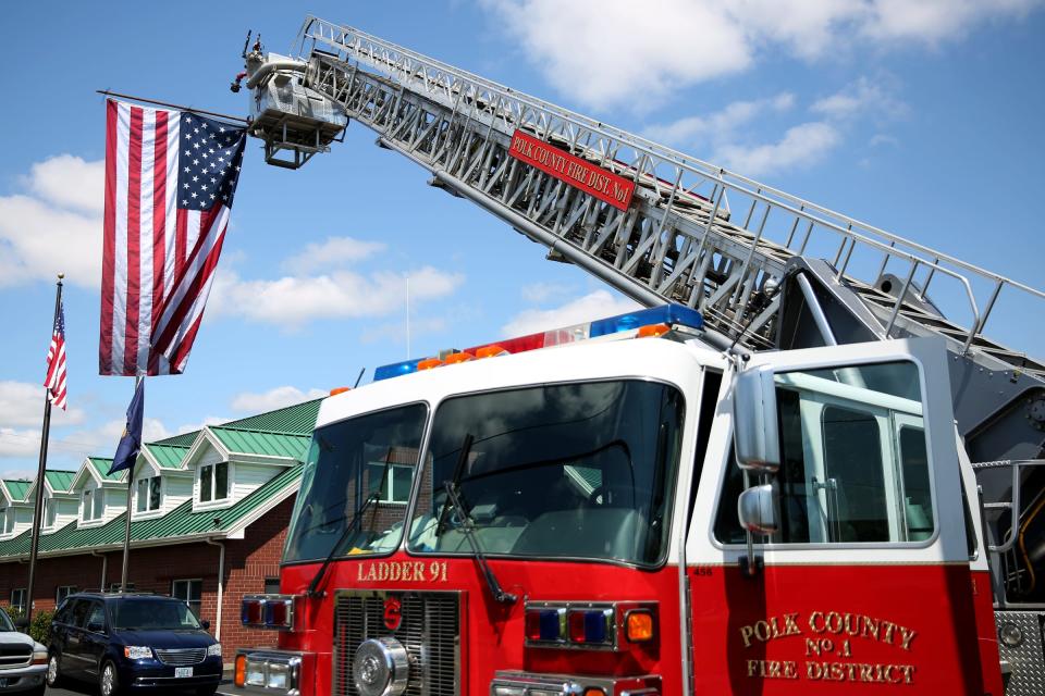 The Polk County Fire District displays a giant American flag during the Independence Days Parade running from Monmouth to Independence on July 4, 2019.