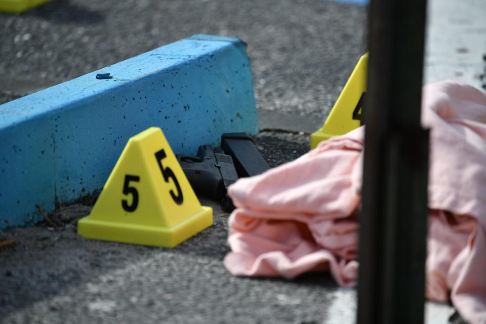 A pistol lies on the ground at the scene of a shooting Friday, Jan. 19, 2024, at the U.S. Post Office at Sarasota Commons on North Beneva Road.