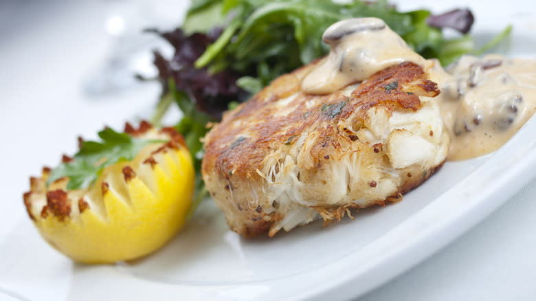 crab cake with greens and sauce