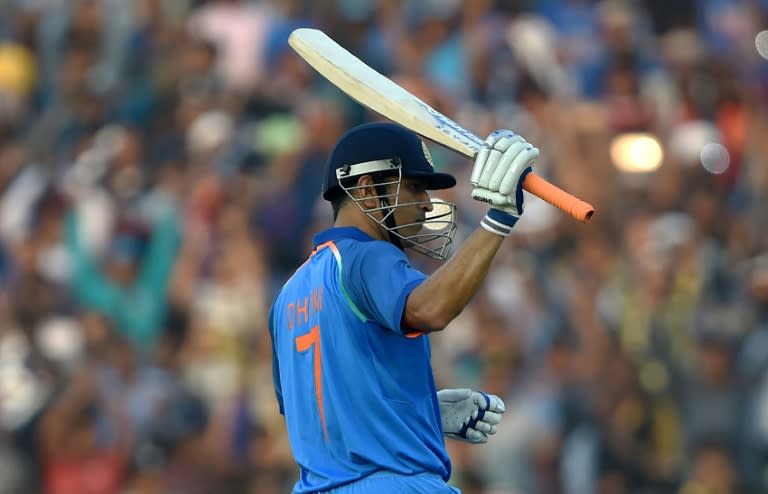 India's Mahendra Singh Dhoni raises his bat after completing his century during the second one-day International against England in Cuttack on January 19, 2017