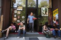 <h2>Waiting tables in Sarajevo</h2> Almin Dzafic, a 30 year-old waiter, poses for a picture as he serves customers in the Galerija Boris Smoje cafe in Sarajevo, May 11, 2012. Dzafic studied for four years at Sarajevo University where he received a degree in civil engineering. For the last four years he has tried to find a job in art restoration but has been working as a waiter for two years. He sees his future outside of Bosnia and Herzegovina because he can not find a job.