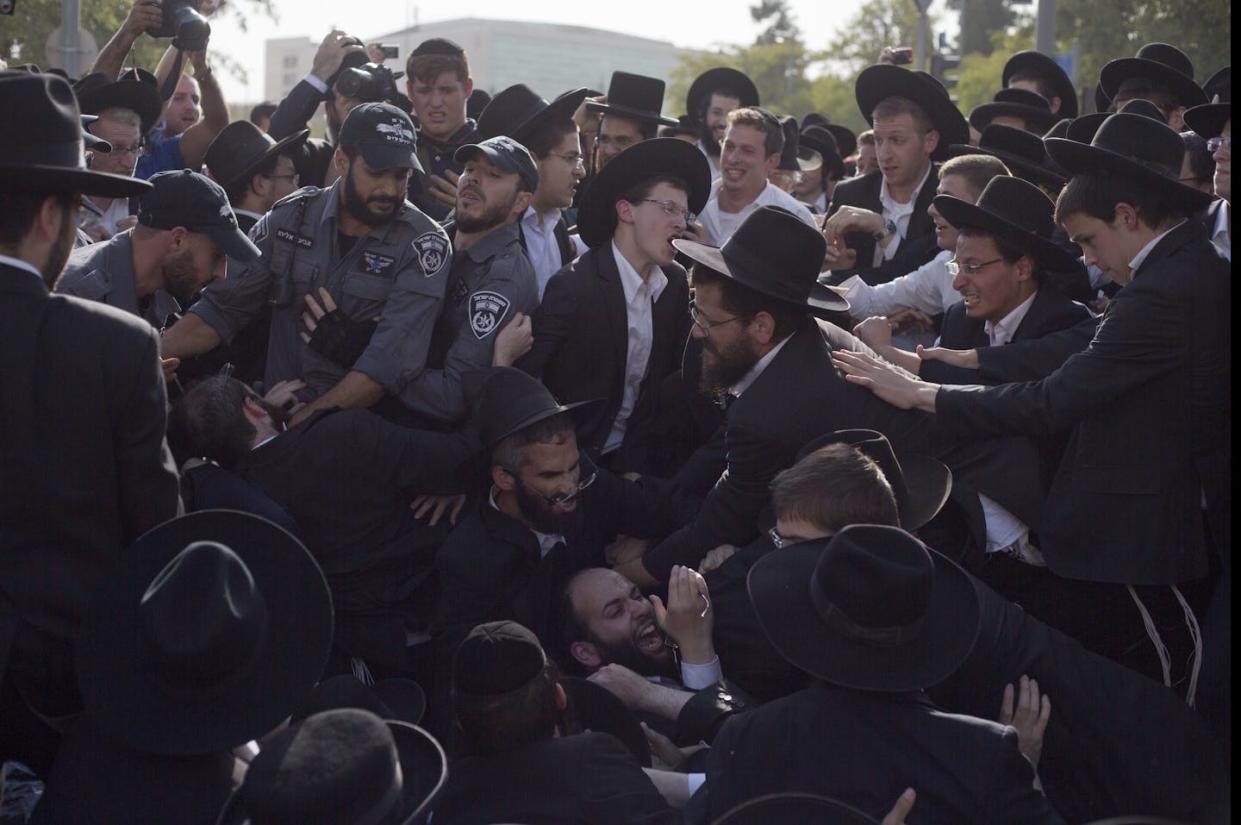 Israeli police scuffle with ultra-Orthodox Jews as they block a main road in Jerusalem during an October 2017 protest against Israeli army conscription. <a href="https://newsroom.ap.org/detail/IsraelUltraOrthodoxDraft/76efc6b6fbbb42f1adbf903862cc7401/photo?Query=israel%20army%20ultra-orthodox&mediaType=photo&sortBy=arrivaldatetime:desc&dateRange=Anytime&totalCount=63&currentItemNo=21" rel="nofollow noopener" target="_blank" data-ylk="slk:AP Photo/Ariel Schalit, File;elm:context_link;itc:0;sec:content-canvas" class="link ">AP Photo/Ariel Schalit, File</a>