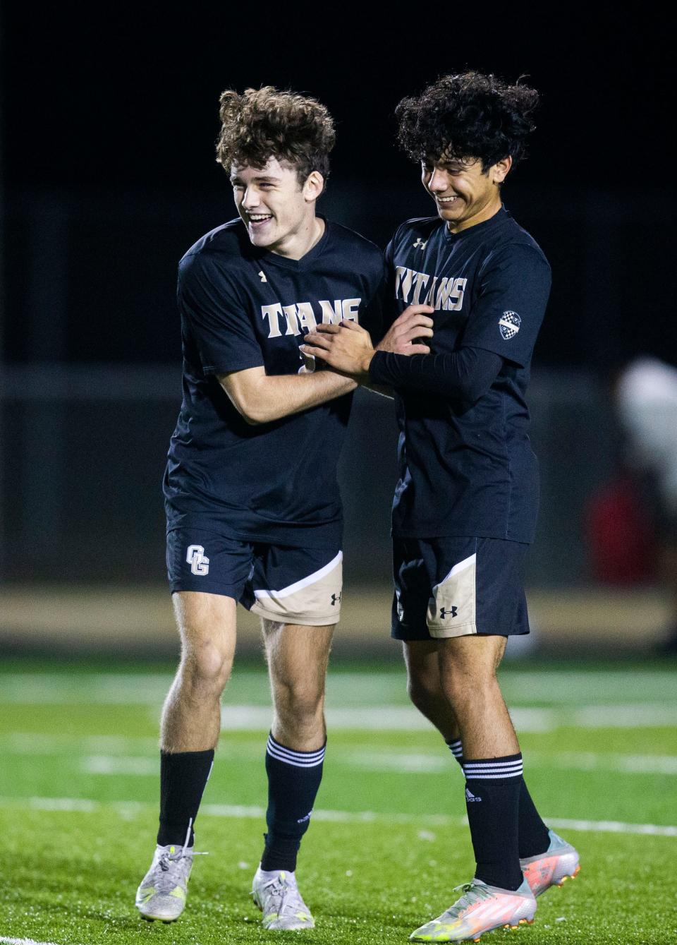 Golden Gate's Gregory Breston (22) and Golden Gate's Christian Rico (6) celebrate the team's win after the boys high school soccer game between Golden Gate and Gulf Coast on Tuesday, Jan. 18, 2022 at Golden Gate High School in Naples, Fla. 