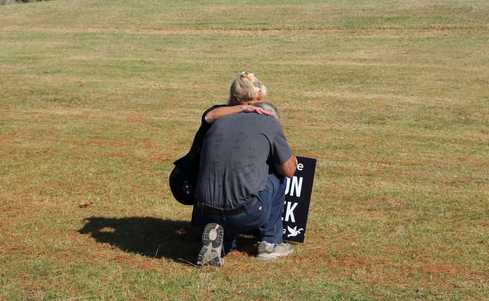 Ronnie Aebischer, who said he is James Coddington's cousin, is consoled after learning the execution had started 
Thursday. He joined others who oppose the death penalty near the governor's mansion to protest the execution.