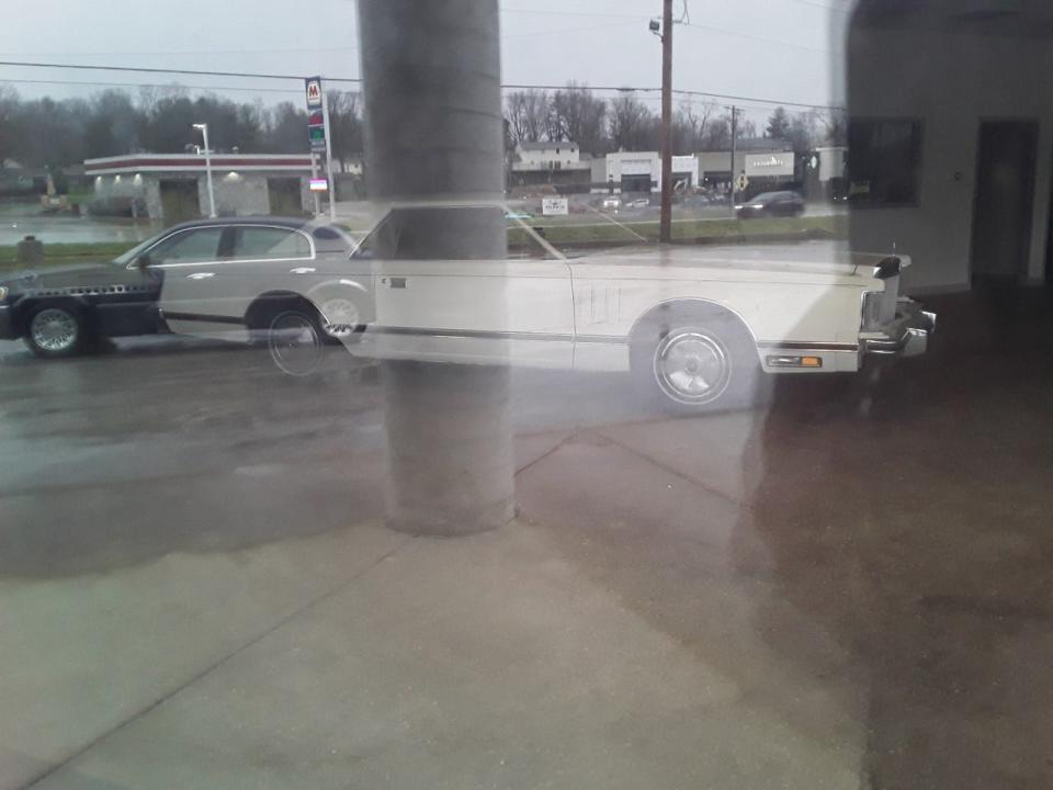 Reader Frank Coffin from Owen County submitted this photo he took through a window, wondering about the car parked inside an old showroom.